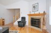 hardwood with wood burning corner fireplace.jpg